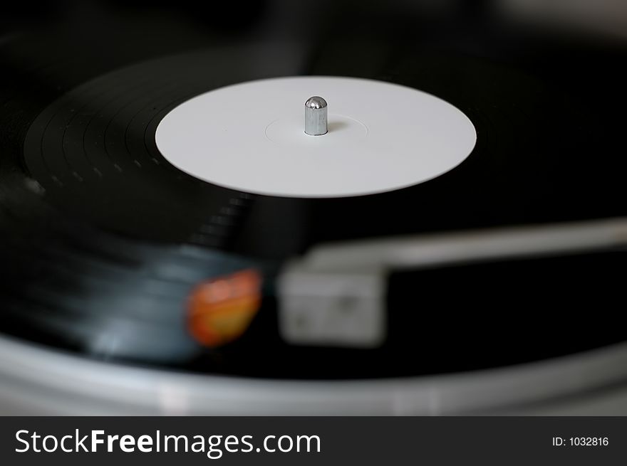 Playing a vinyl record on a turntable. Playing a vinyl record on a turntable.