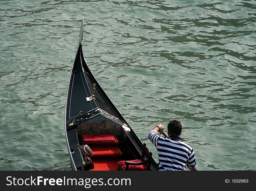 A gondolier tackles the Grand Canal in Venice, Italy.