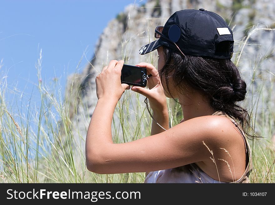 Young girl taking a snapshot. Young girl taking a snapshot