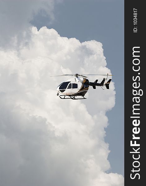 Storm clouds building, helecopter passing by. Storm clouds building, helecopter passing by