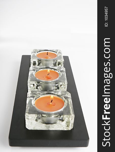Ice orange candles on a black holder. Ice orange candles on a black holder