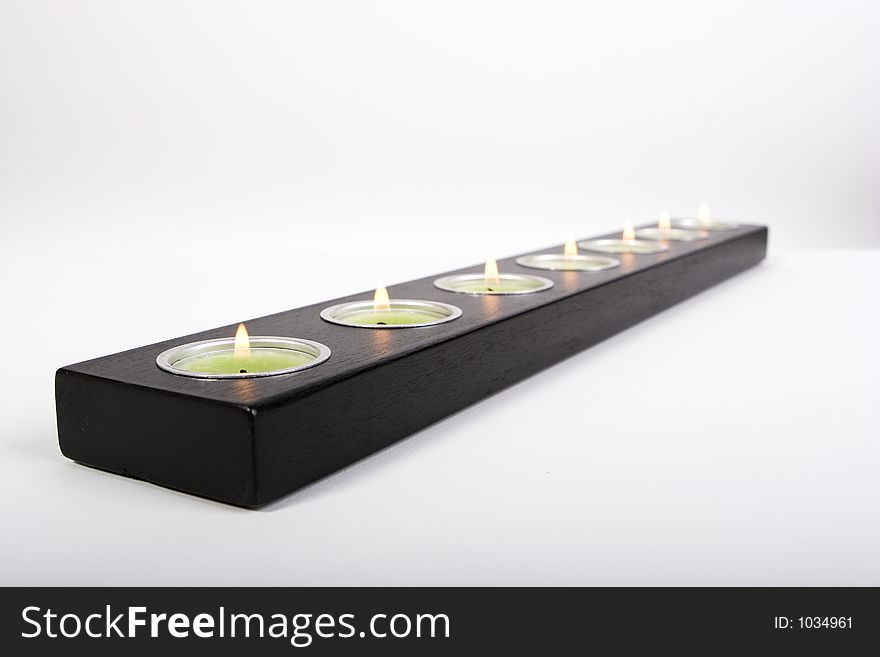 Green candles on a black holder. Green candles on a black holder