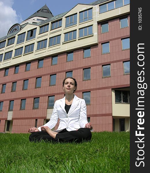 Yoga businesswoman on grass