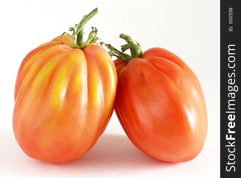 Two beef tomatoes in love close-up. Two beef tomatoes in love close-up