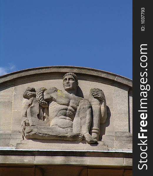 Art deco sculpture of man on palace building