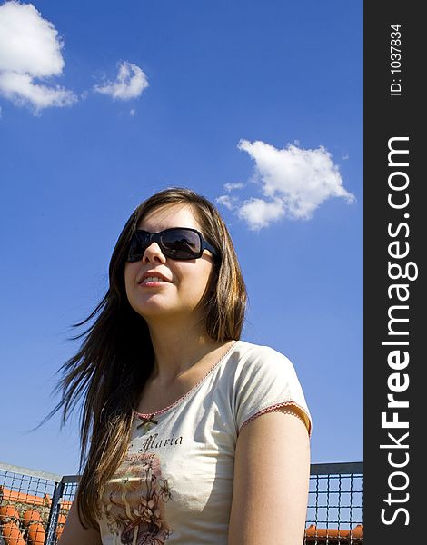 Sitting brunette on blue sky. Sitting brunette on blue sky