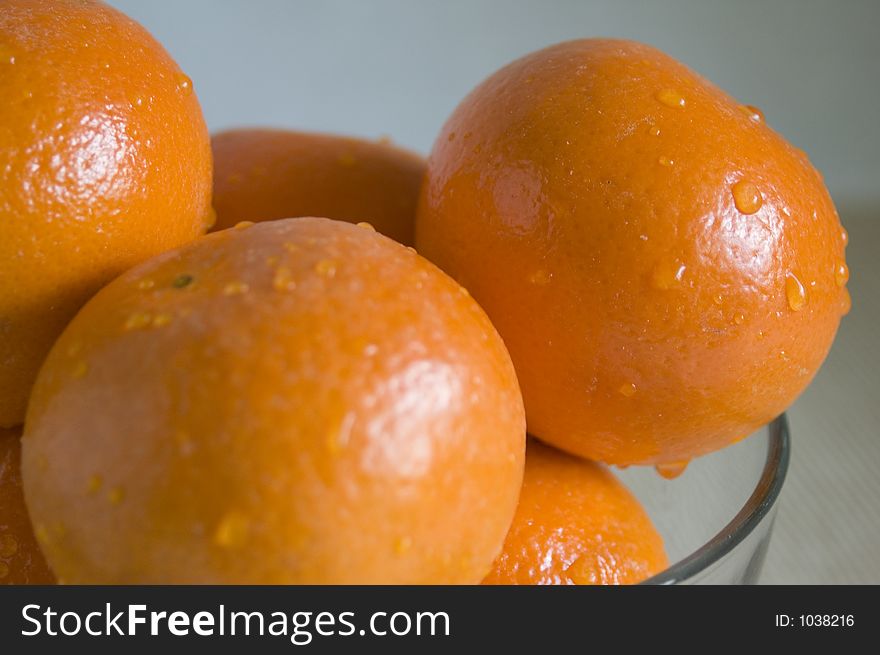 Mandarin oranges in a glass bowl.