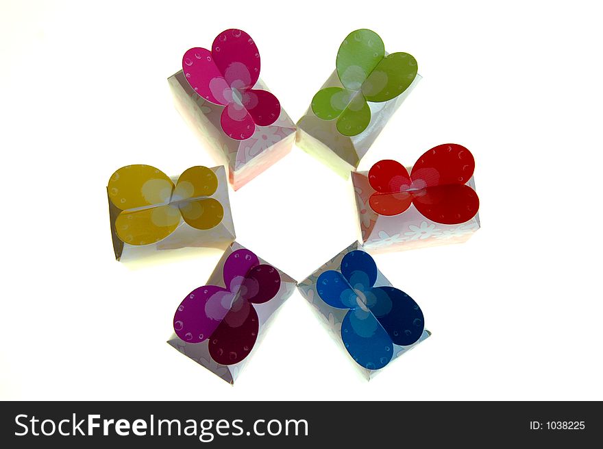 Colorful butterfly gift boxes arranged in a circle on a white background. Colorful butterfly gift boxes arranged in a circle on a white background.