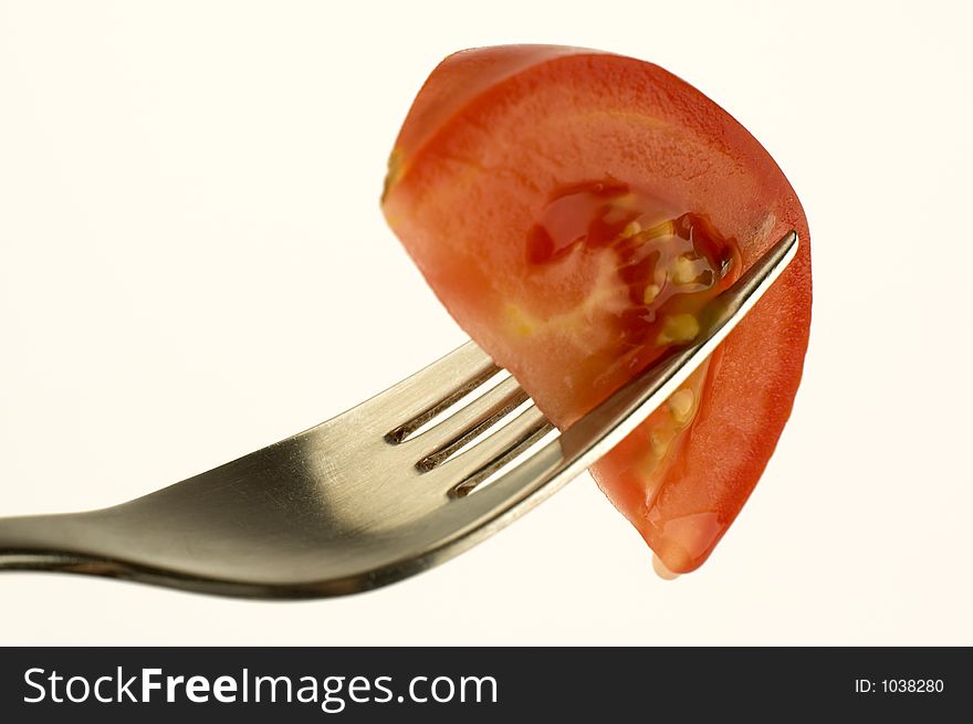 Tomato piece on a fork. Tomato piece on a fork