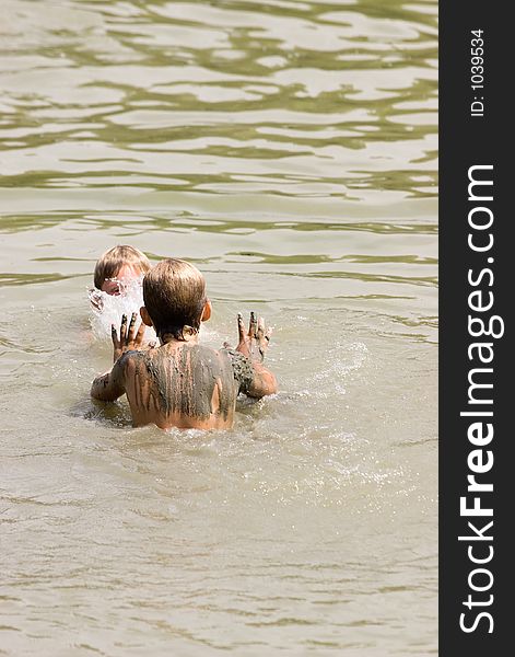 Two children playing in the water. Two children playing in the water