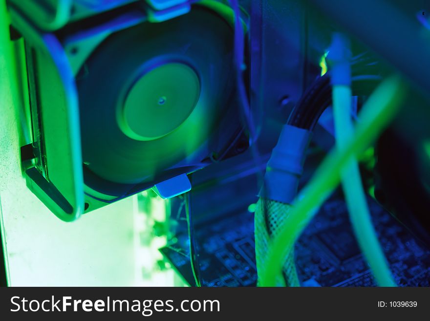 Computer case fan under light of green cathode spinning. Captured with a Canon EOS 3 with Provia 100F or Velvia 100.