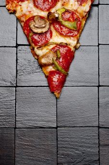 Pizza On A Black Wooden Background Royalty Free Stock Photo