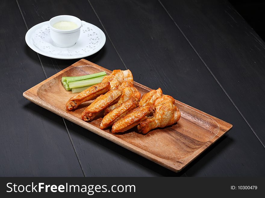 Grilled chicken wings served on wooden board