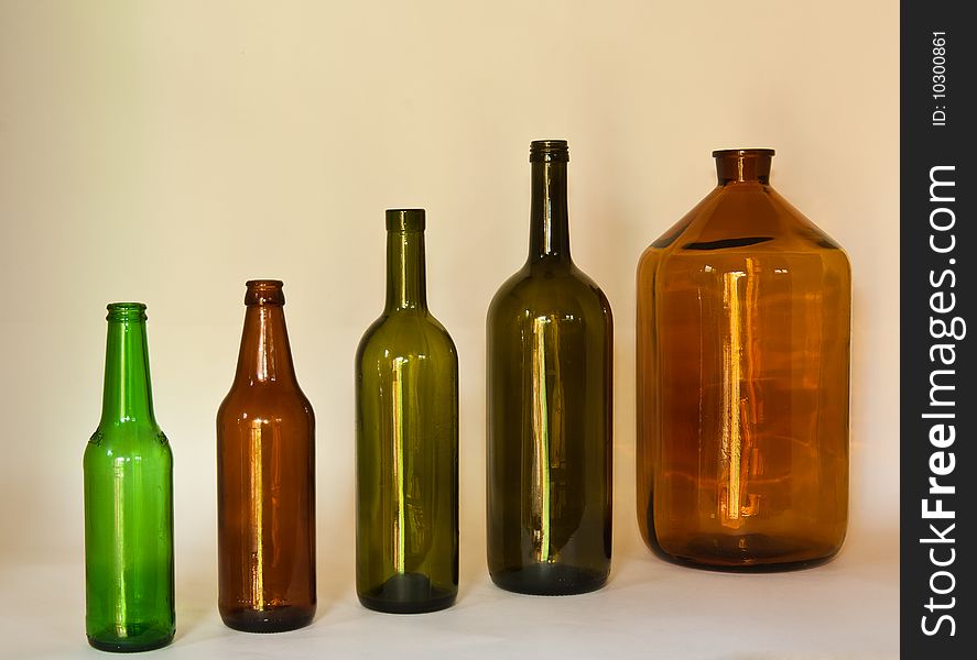 Ascending row of dark glass bottles. Ascending row of dark glass bottles