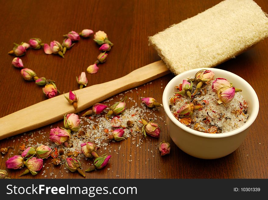 Still life with bath salt, loofah, and roses in a love heart. Still life with bath salt, loofah, and roses in a love heart