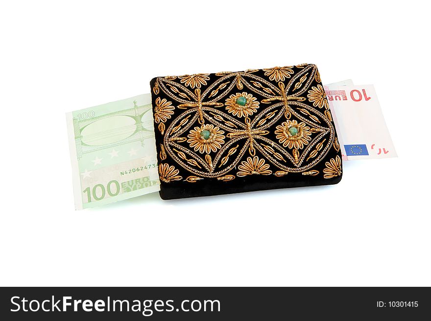 Embroidered woman's purse and euro banknotes isolated. Embroidered woman's purse and euro banknotes isolated