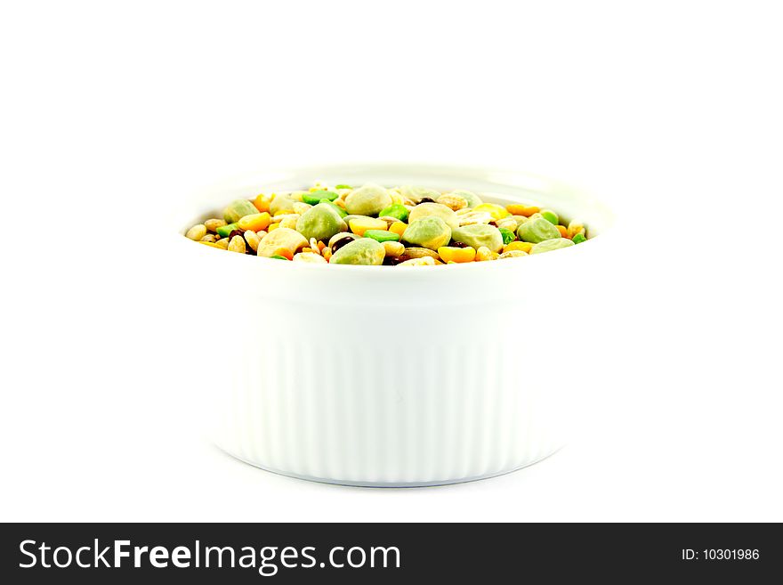 Assorted soup pulses in a small round dish with a white background