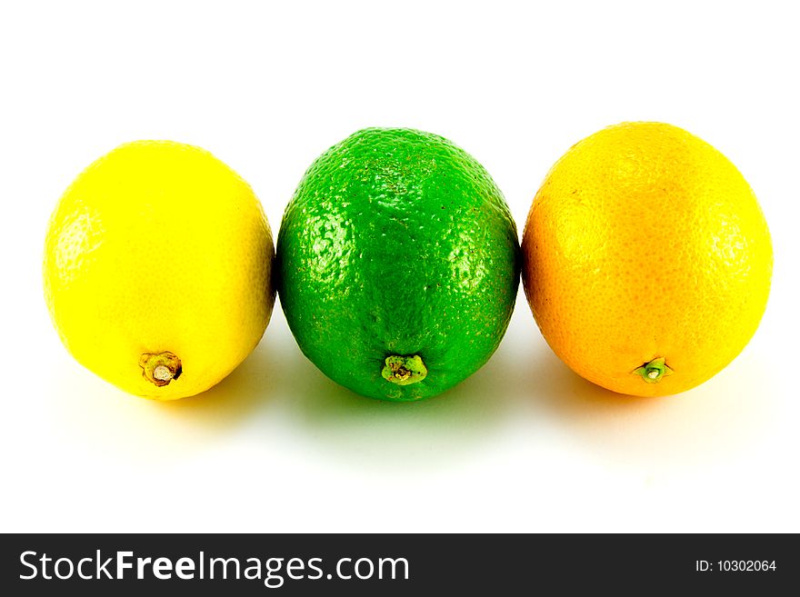Single whole lemon, Lime and Orange standing in a row on a white background. Single whole lemon, Lime and Orange standing in a row on a white background