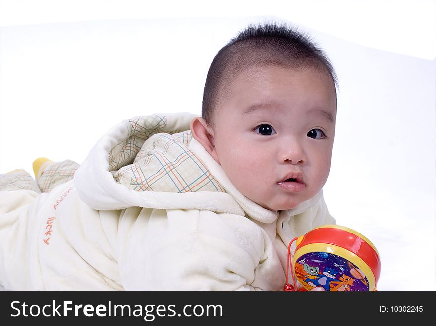 A baby sitting on the white background. A baby sitting on the white background