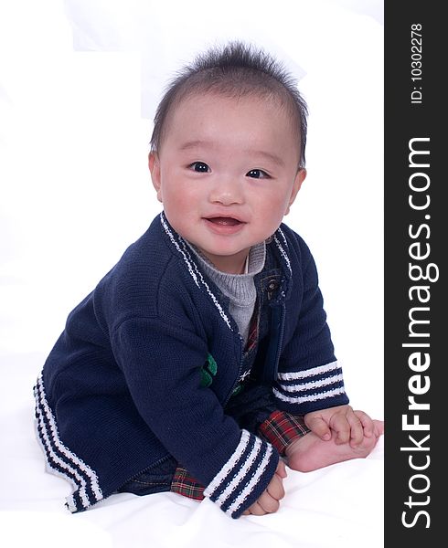 A baby sitting on the white background. A baby sitting on the white background