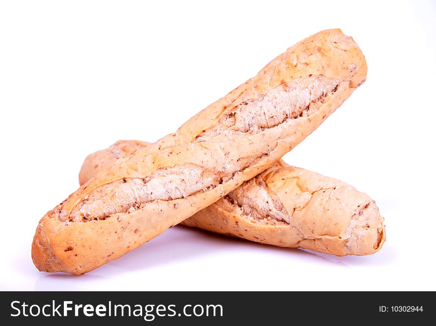 Two fresh brown baguettes on a white background. Two fresh brown baguettes on a white background.