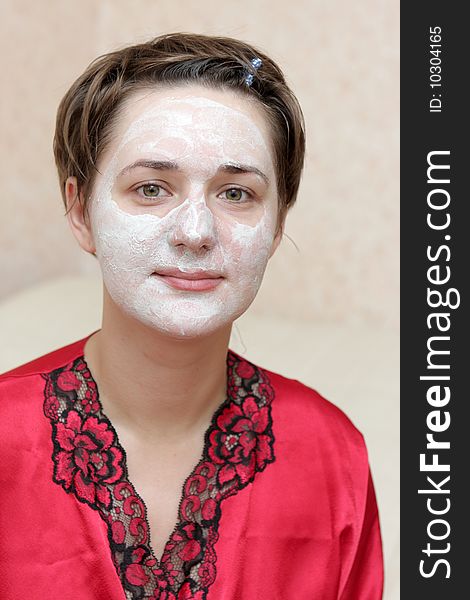 The housewife with face mask at home