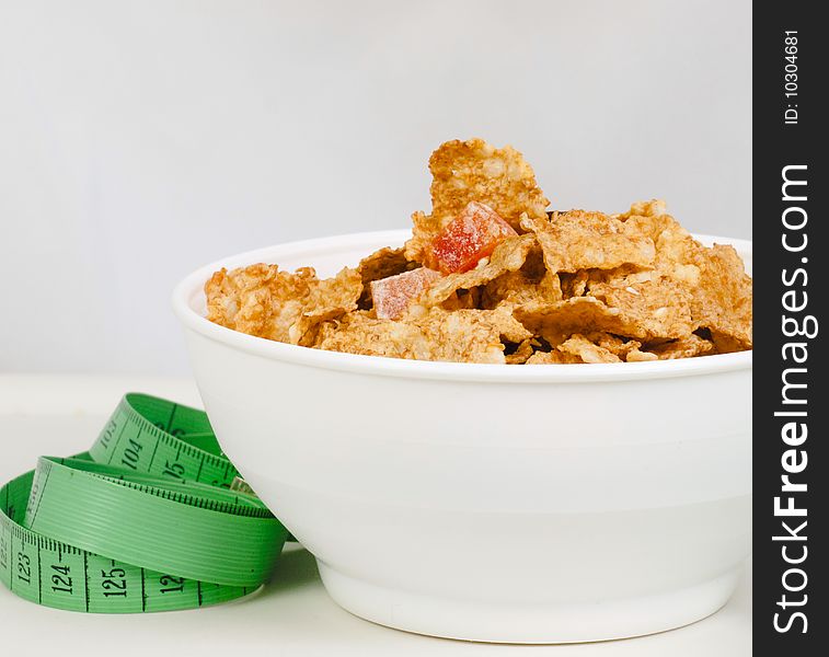 Measurement tape wrapped around dish with flakes