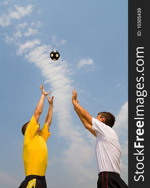 Teenagers catch a flying in sky ball