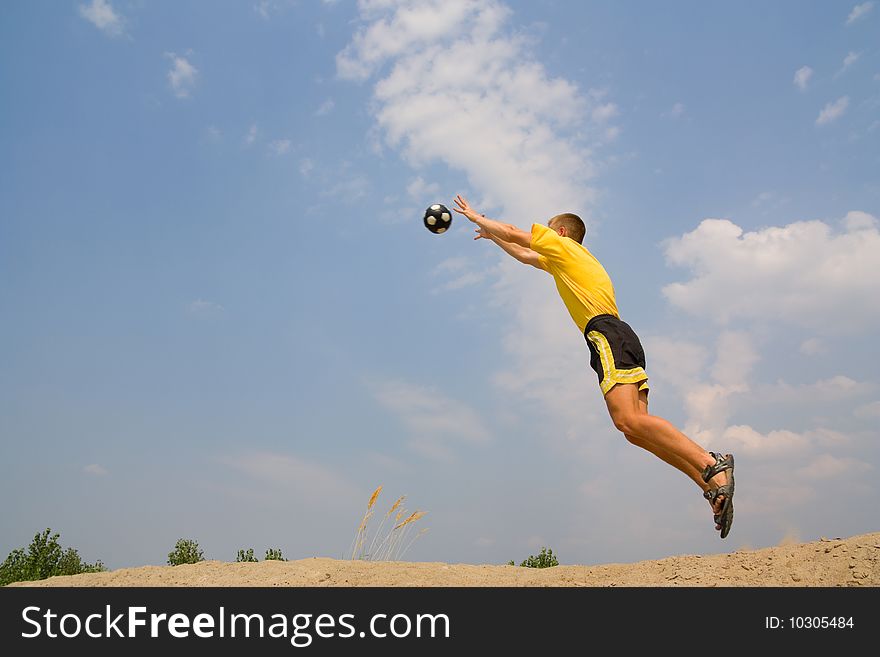 A teenager in a jump catches a ball