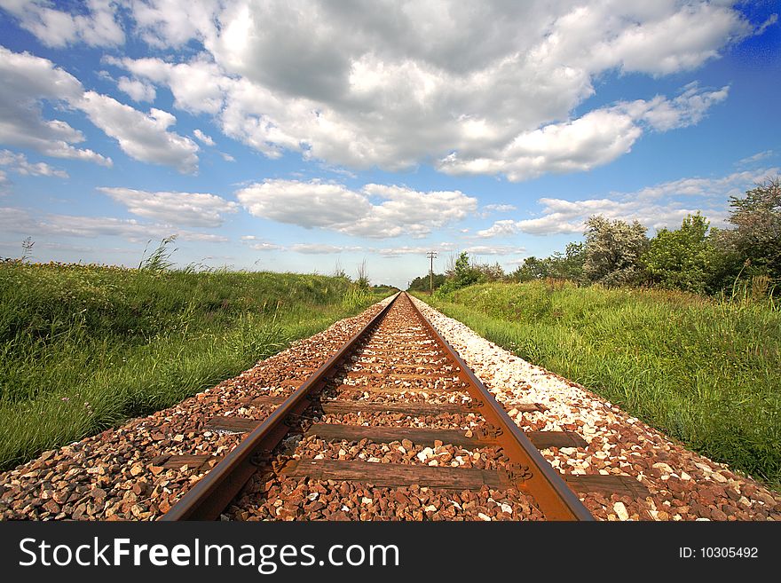 Railway tracks disappearing into distance.