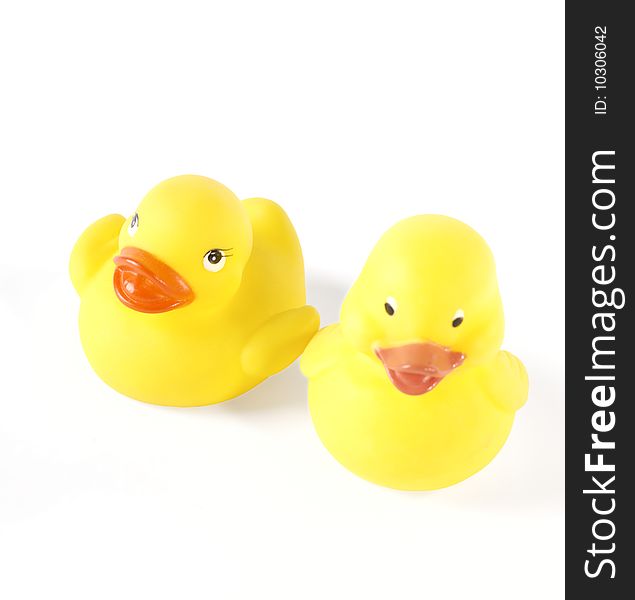 Two yellow plastic toy Ducks with shadows. Isolated with clipping path