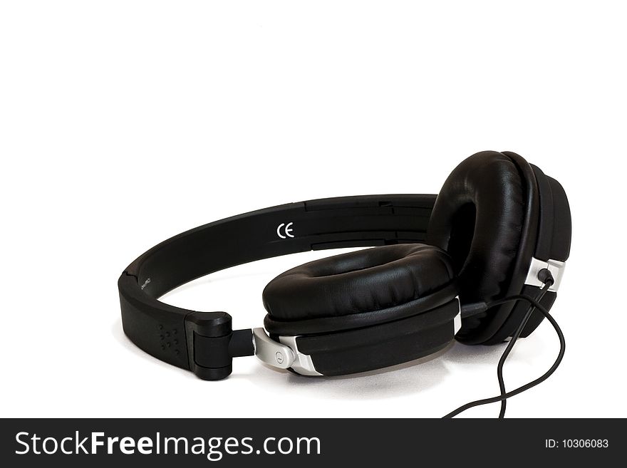 Black headphones on a white background with space for copy