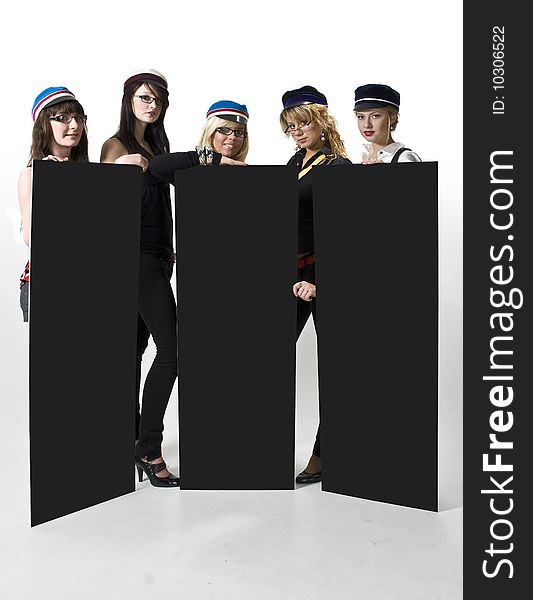 Team of five young women in generic university caps holding three blank posters. Team of five young women in generic university caps holding three blank posters.