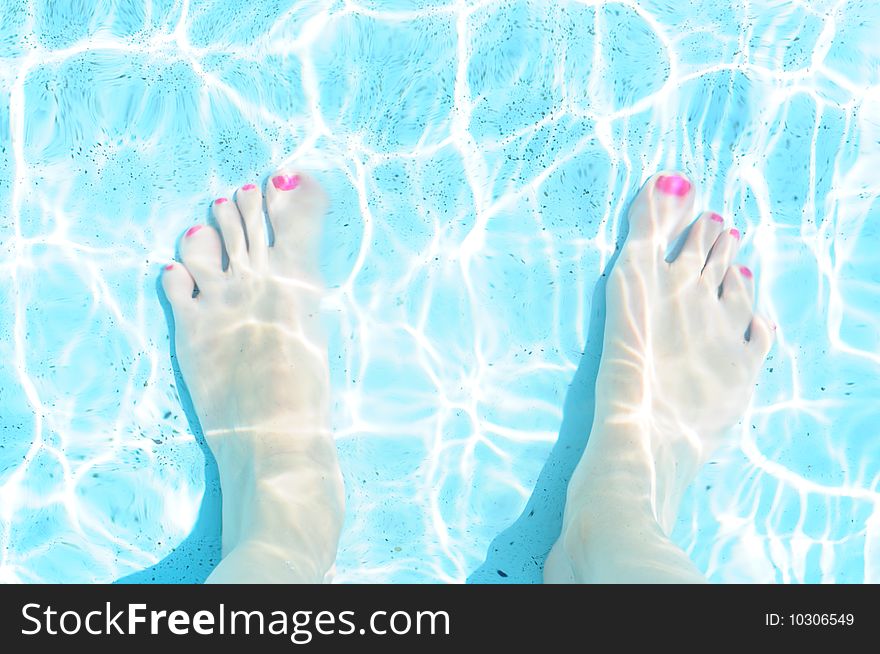 Woman feet in the pool. Woman feet in the pool