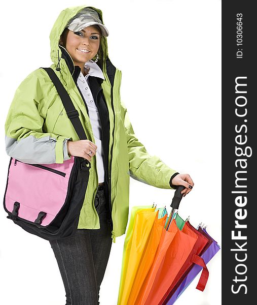 Happy young girl in seasonal outfit, for autumn or spring. Wind jacket and colorful umbrella.