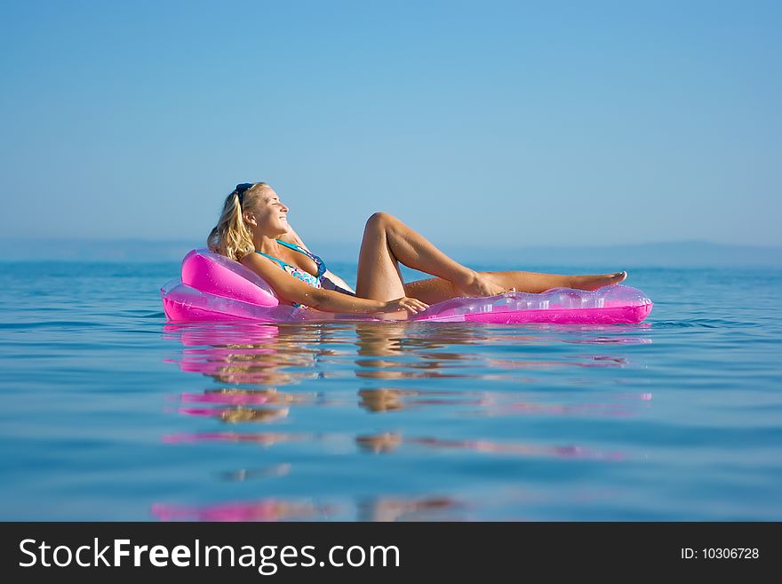 Blonde girl on inflatable raft