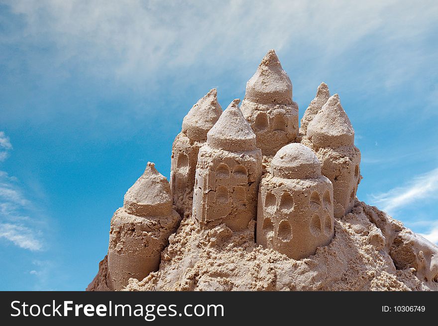 Sand castle on blue sky background with clipping path. Sand castle on blue sky background with clipping path.