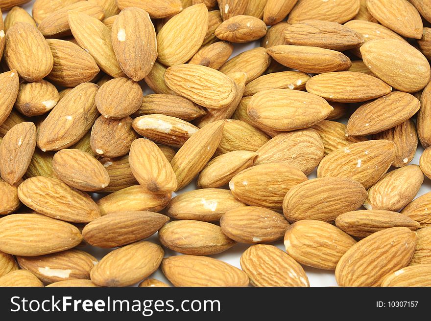 A background filled with tasty healthy almonds. A background filled with tasty healthy almonds.