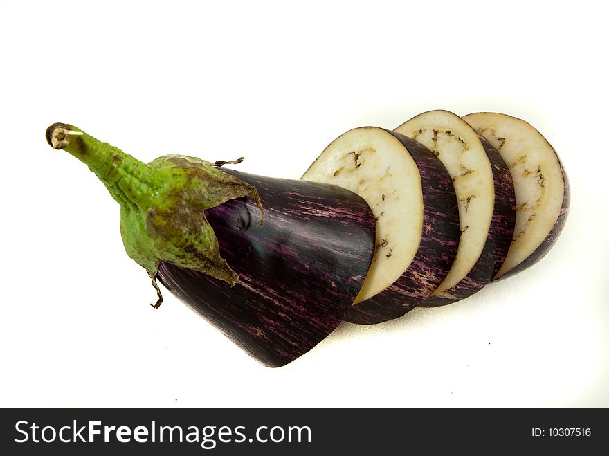 Aubergine is sliced to three slices, background is white. Aubergine is sliced to three slices, background is white