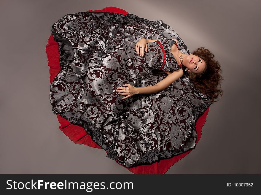 Woman with closed eyes laying on floor separated over gray