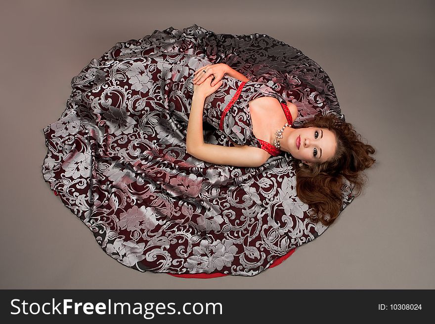 Girl with open eyes laying on floor isolated