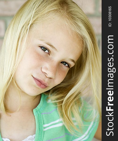 A beautiful little blonde haired girl, vertical with copy space