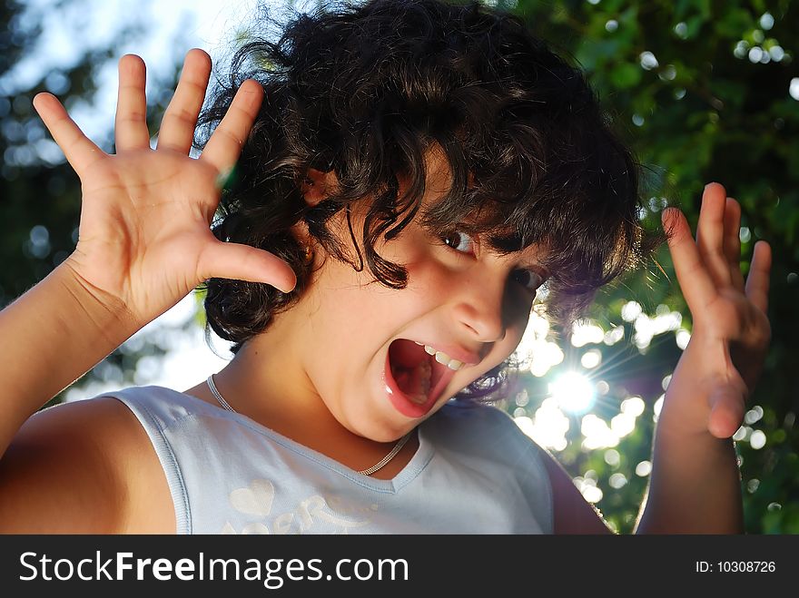 Girl screaming with her hands up. Girl screaming with her hands up