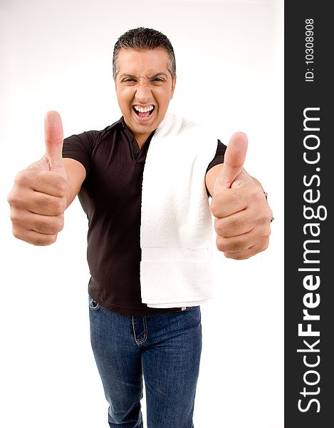 Happy male showing thumbs up with towel on shoulders