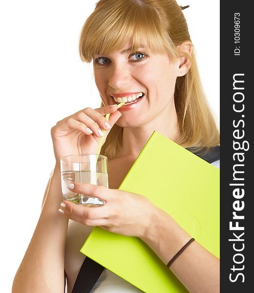 The young student drinks water from a glass on a white background. The young student drinks water from a glass on a white background