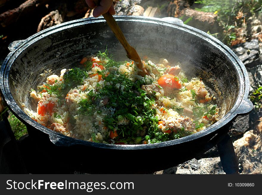 Sweet tasty pilaf, cooked in the fire, prepared for the chief cook of Uzbekistan, on the nature of a very tasty and nourishing plov, the Uzbek national dish,. Sweet tasty pilaf, cooked in the fire, prepared for the chief cook of Uzbekistan, on the nature of a very tasty and nourishing plov, the Uzbek national dish,