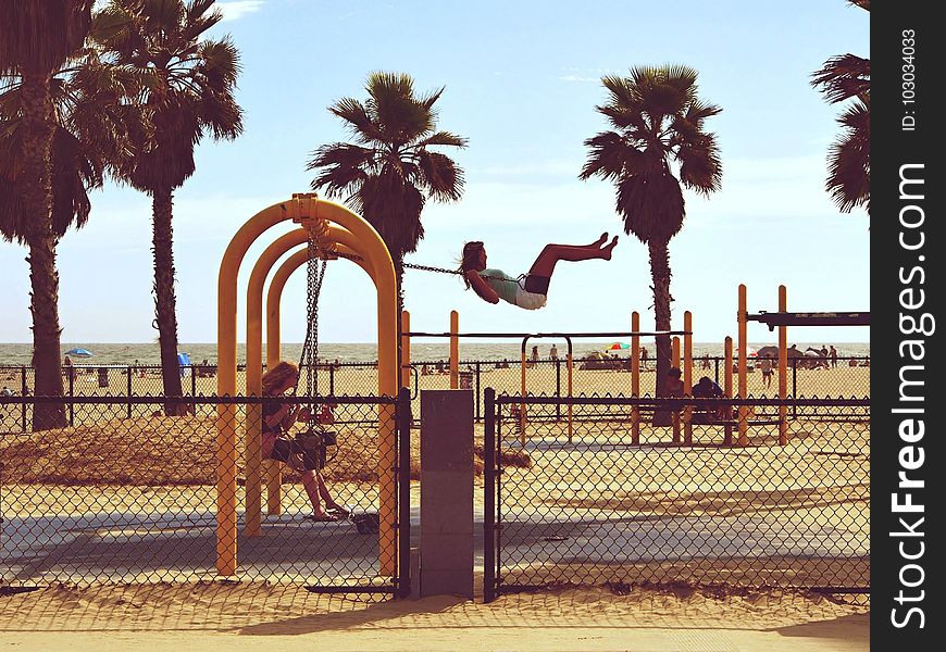 Woman Playing Swing Near Beach