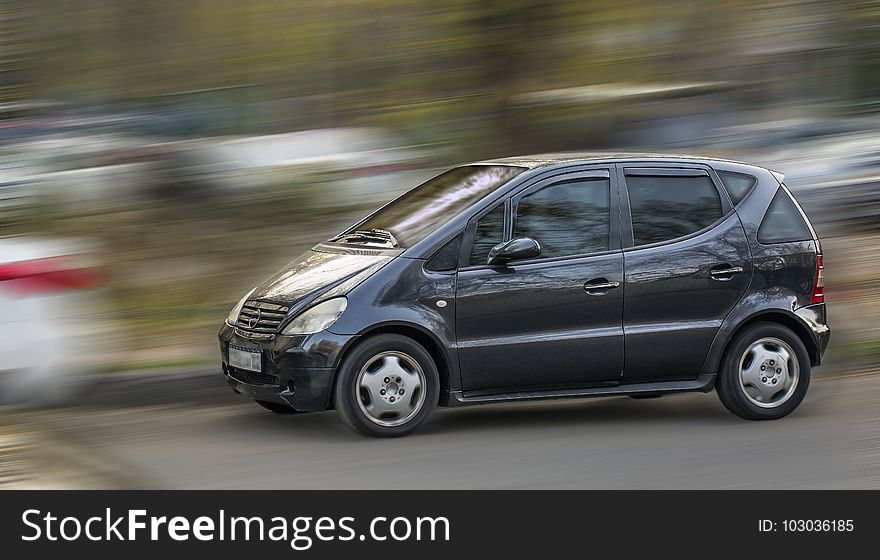 A compact Mercedes car on a blurred background. A compact Mercedes car on a blurred background.