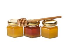 Honey In Bottles And Wooden Dipper Isolated Stock Photos Honey In Bottles And Wooden Dipper Isolated Stock Photos