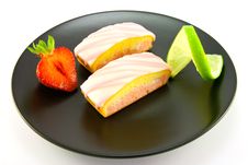 Strawberry Slices On A Black Plate Stock Photos
